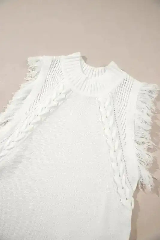 Detailed view of white tasseled woven knit tank top with mock neckline and fringe-trimmed sleeves, ideal for casual summer wear.