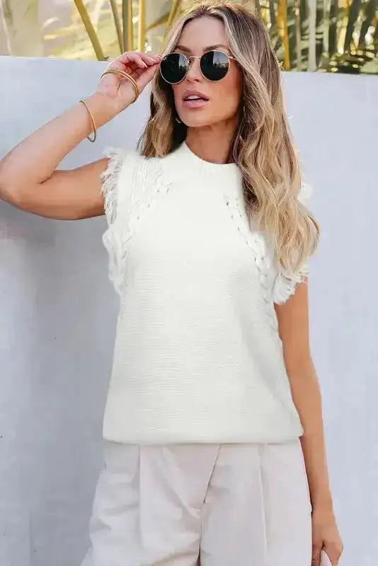 White tasseled woven knit tank top with sleeveless design and textured fringe accents, perfect for warm-weather boho styling.
