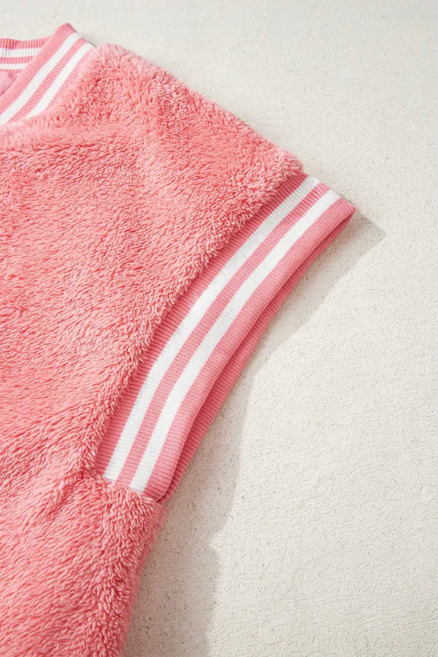 Collar and shoulder seam detail on pink sherpa vest