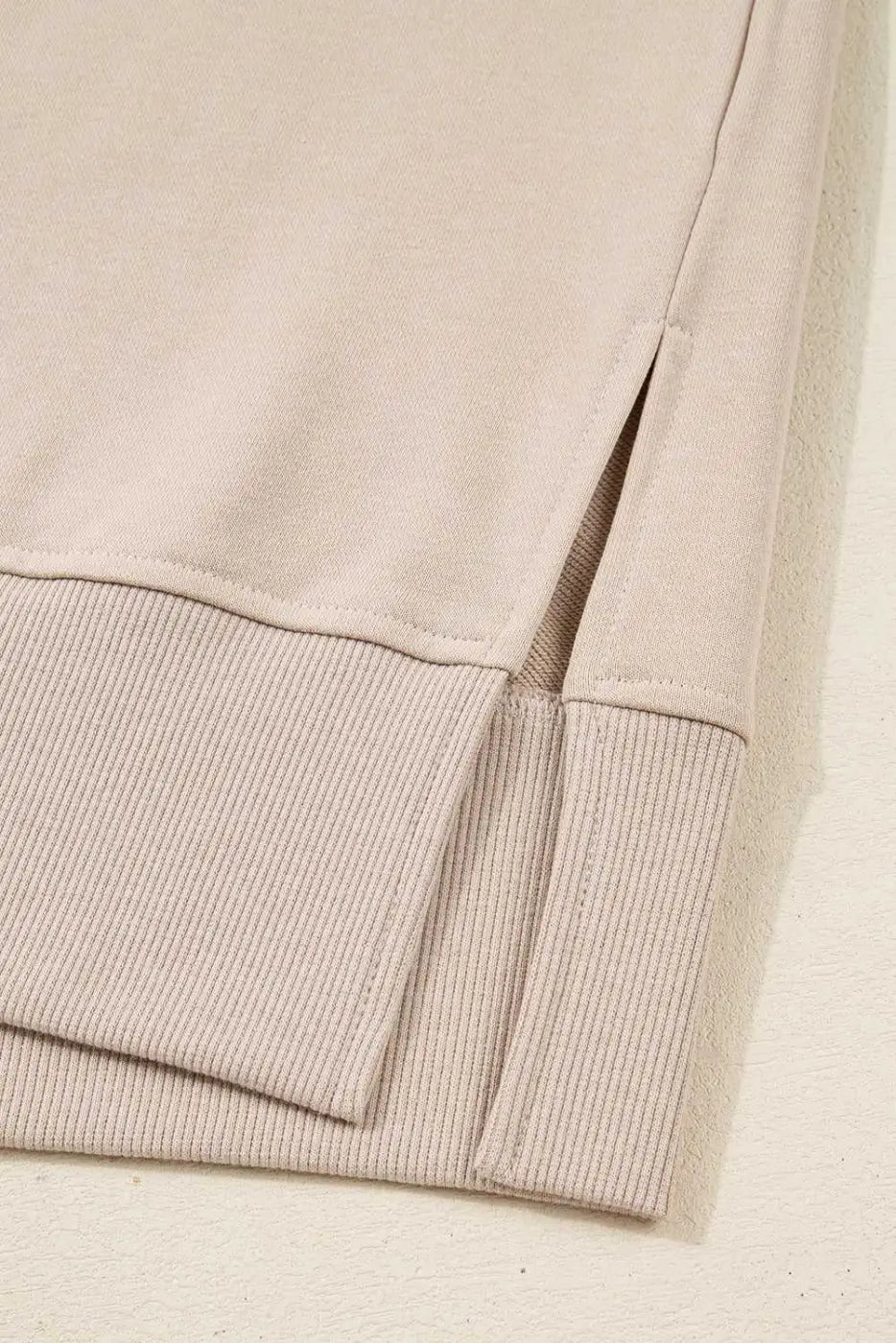 Detail of hem and side slit on beige Oversized Sweatshirt, part of the Matching Set designed for comfort and modern casual style.